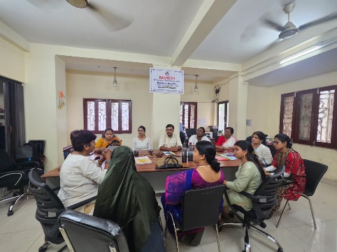 Teachers and project staff seated around a table during the MKSS orientation programme